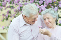 happy couple with flower arrangement